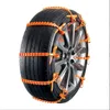 A car tire with orange snow chains attached, shown against a white background. Anteprima dell’immagine prodotto