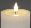 Close-up of the top of a white LED candle with a flame. Produktbild-Vorschau