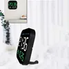 A digital clock is displayed on a shelf, and another digital clock is shown on a fluffy white surface. Produktbild-Vorschau