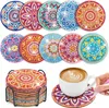 A collection of diamond painting coasters with a holder and a cup of coffee on a coaster. Produktbild-Vorschau