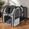A pet carrier is placed on a wooden floor next to a potted plant. Produktbild-Vorschau