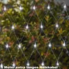 A net of white LED lights is draped over a bush or hedge, with the lights illuminated. Produktbild-Vorschau