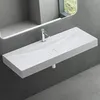 A modern white washbasin mounted on a gray wall, with a mirror reflecting a window and greenery. Produktbild-Vorschau