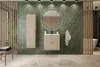 A modern bathroom with a vanity, mirror, and storage cabinet against a green tiled wall. Produktbild-Vorschau
