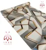 A roll of self-adhesive wallpaper with a geometric pattern is shown diagonally against a white background. Two logos with the text 'IKHE MALARKA' are visible in the corners. Anteprima dell’immagine prodotto