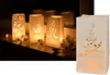 A collage of Christmas-themed paper lanterns with cut-out designs, some lit from within, and a separate lantern with a Christmas tree design. Produktbild-Vorschau