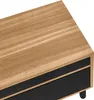 A close-up view of the top and front of a piece of furniture, likely a TV stand or cabinet, showing the wood grain texture on the top surface and a ribbed black design on the front. Produktbild-Vorschau