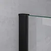 Close-up of a black frame and a glass panel, likely part of a shower enclosure, against a textured gray wall. Produktbild-Vorschau