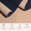 A rolled-up yoga mat made of cork and dark blue material, with icons and text at the bottom indicating product features. Náhľad obrázku produktu