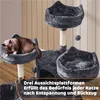 A multi-level cat tree with a cat sleeping on one of the platforms, set against a light-colored, paneled wall. Produktbild-Vorschau