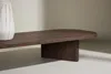A close-up of a wooden coffee table with a textured vase on the left. Produktbild-Vorschau
