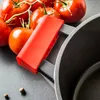 A close-up shot of a pot handle and tomatoes. Podgląd zdjęcia produktu