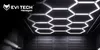 A modern ceiling with hexagonal LED lights and a dark, textured wall. Náhled obrázku produktu