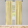 Two yellow and champagne striped curtains hanging in front of a window. Anteprima dell’immagine prodotto
