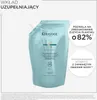 A refill pouch of Kérastase shampoo with marketing text overlays. Produktbild-Vorschau