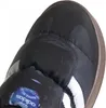 Close-up view of the toe of a black Adidas sneaker with white stripes and a blue Adidas logo tag. Podgląd zdjęcia produktu