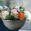 A close-up view of a floral arrangement in a pot. Produktbild-Vorschau