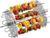 Three metal skewers loaded with food items like meat, corn, bell peppers, and onions, arranged in a diagonal formation against a white background. Produktbild-Vorschau