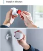 Hands installing a white motion sensor onto a wall mount. Produktbild-Vorschau