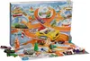 A Hot Wheels advent calendar with toy cars and accessories displayed on a snowy track scene. Produktbild-Vorschau