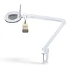 A white magnifying lamp with an adjustable arm and clamp base, shown against a white background. A tag with text is attached to the lamp. Produktbild-Vorschau
