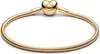 A close-up studio shot of a gold Pandora bracelet with a heart-shaped clasp. Podgląd zdjęcia produktu