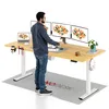 A man is standing at a standing desk with multiple monitors and a laptop. Podgląd zdjęcia produktu