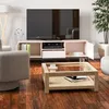A living room scene with a TV stand, TV, coffee table, and armchair. Produktbild-Vorschau