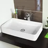 A white ceramic rectangular sink with a chrome faucet and drain is shown on a dark wooden shelf against a brown tiled backsplash. Náhled obrázku produktu