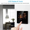 A hand is shown touching a smart digital thermostat mounted on a wall, with a room interior in the background. Náhled obrázku produktu
