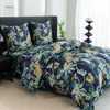 A bed with a duvet cover and pillows featuring a jungle print with wild cats and tropical plants. Náhled obrázku produktu