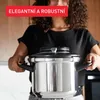 A person holding a pressure cooker. Voir les images du produit