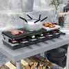 A raclette grill set is displayed on a table outdoors, with food being cooked on it. Náhľad obrázku produktu