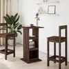 A dark wood bar table with shelves and two bar stools in a room with a large plant and white curtains. Voir les images du produit