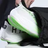 A person is putting a pair of Puma running shoes into a black gym sack. Produktbild-Vorschau