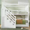 A white bunk bed with stairs and storage drawers, set against a light green wall with a mountain-like pattern. Anteprima dell’immagine prodotto