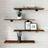Four wooden shelves mounted on a white brick wall, decorated with a plant, two framed pictures, and a container of pencils. Anteprima dell’immagine prodotto