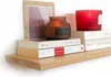 A wooden shelf with decorative items and books. Produktbild-Vorschau