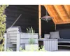 An outdoor seating area with a sofa, chairs, and a coffee table under a wooden roof. Náhled obrázku produktu