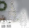 A decorative metal Christmas tree with LED lights, shown indoors with a wreath and gift boxes in the background. A smaller version of the tree is visible on the right. Podgląd zdjęcia produktu