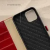 A close-up shot of the interior of a red leather phone case, showing the soft microfiber lining and the embossed brand name. Produktbild-Vorschau