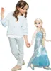 A young girl and a large Elsa doll are standing and holding hands against a white background. Produktbild-Vorschau