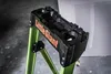 A close-up shot of the top section of a Little Giant MightyLite ladder, showing the black plastic utility top with orange branding. Podgląd zdjęcia produktu