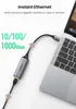 A USB-C to Ethernet adapter connected to a laptop. Voir les images du produit