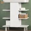 A white bathroom vanity cabinet with shelves against a green wall. Voir les images du produit