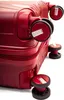 Close-up view of the wheels and lower section of a red suitcase. Podgląd zdjęcia produktu