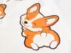 A close-up of a cartoon corgi dog print on a white fabric. Anteprima dell’immagine prodotto