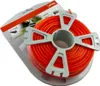 A spool of orange trimmer line on a gray plastic holder, with packaging in the background. Anteprima dell’immagine prodotto