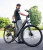 A person standing next to an e-bike outdoors. Produktbild-Vorschau