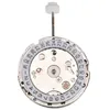 A close-up, top-down view of a watch movement with a date complication, set against a white background. Náhled obrázku produktu
